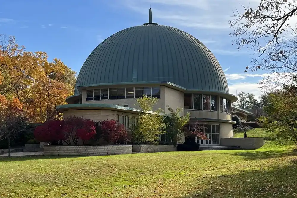 The green copper dome of the Park Synagogue building among autumn trees in Cleveland Heights, Ohio